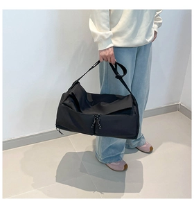 Detailed view of black nylon fitness bag with adjustable strap and braided zipper pullers