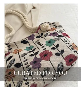 Detail of vintage canvas tote featuring colorful floral print and thick cotton rope handles