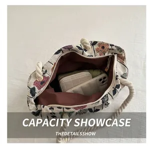 Detail showing spacious interior of the floral canvas tote bag with hemp rope handles
