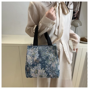Detail of floral jacquard tote bag showing vintage texture and durable fabric handles