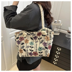 Close-up of floral jacquard tote bag featuring vibrant weave patterns and thick rope handles