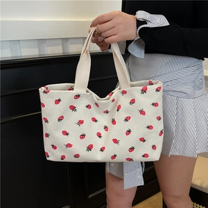 Chic corduroy tote bag featuring red strawberry prints for casual summer fashion