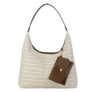 Large woven straw tote bag with brown leather handles and a matching mini pouch
