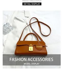 Close-up of caramel retro crossbody bag with golden padlock hardware and slim strap