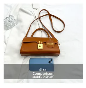 Caramel brown leather crossbody bag shown next to a smartphone for size comparison