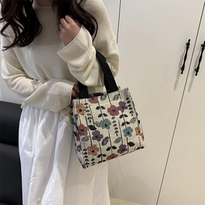 Vintage floral tapestry tote bag with colorful embroidery and black straps