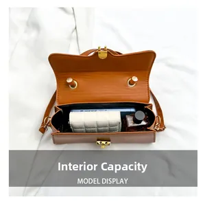 Interior view of caramel crossbody bag showing space for phone, wallet and perfume