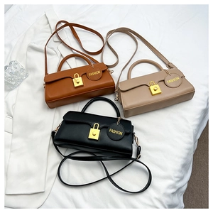 Detailed view of rectangular PU leather bags in brown, beige and black with gold clasps
