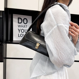 Minimalist black faux leather crescent shoulder bag with golden buckle for women