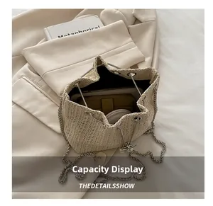 Top view of straw bucket bag interior showing large capacity for phone and wallet