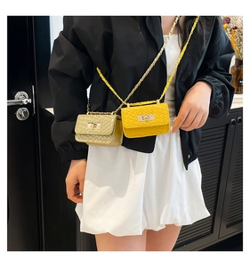 Mini metallic gold and yellow croc-effect chain bags shown on model with metal twist lock