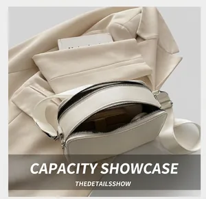 Detailed interior view showing storage capacity of a white double-zipper camera bag