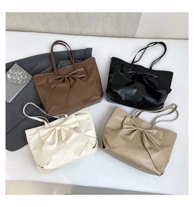 Vue à plat de sacs cabas en marron, noir, blanc et kaki avec détail grand nœud