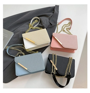 Detail of four colorful crossbody bags with chic woven texture and gold metal accents