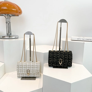 Elegant tweed chain shoulder bags in black and cream white with gold oval twist locks
