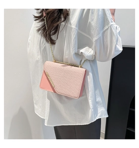 Pink shoulder bag with dual texture and gold chain strap shown from a side-back view