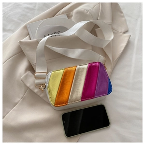 Detail of colorful rainbow camera bag with wide white strap and lychee leather texture