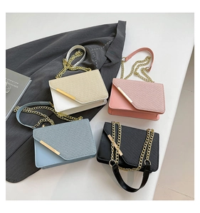 Detail of four colorful crossbody bags with metal edge decor and chain straps
