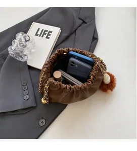 Top view of brown bucket bag interior showing spacious capacity for phones and cosmetics
