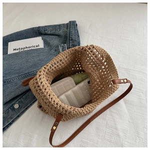 Top view of hollow-out woven tote bag interior showing large capacity and daily essentials