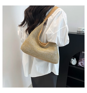 Detail view of woven beige tote bag with leather strap on model for minimalist style
