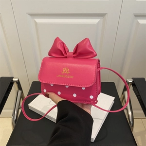 Mini rose pink crossbody bag with large bow and white polka dots for girls