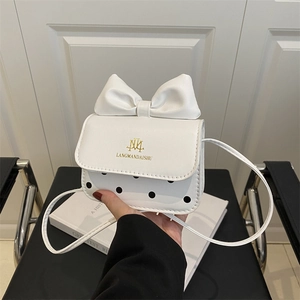 Mini white crossbody bag with black polka dots and a large 3D bow for girls