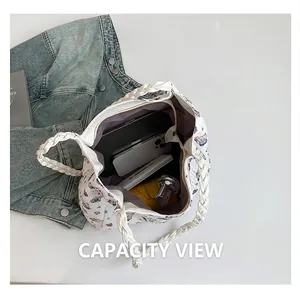 Interior view showing the large capacity of the white canvas bag with cartoon prints