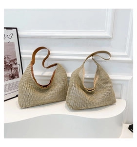 Detail view of woven hollow straw hobo bags with leather handles and fine mesh texture