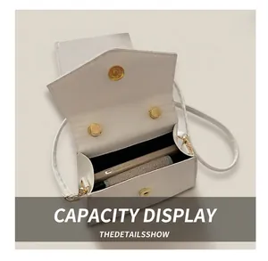Internal capacity of white bow square bag showing phone and pocket inside