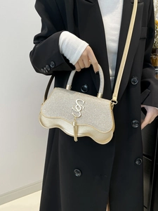 Sparkling gold sequined handbag with metal tassel logo and wavy base for elegant women