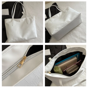 Detail view of large white crocodile pattern tote bag showing texture and interior capacity