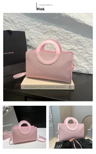 Pink retro crossbody bag detail showing unique circular hollow handle and embossed texture