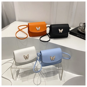 Mini square crossbody bags with metal butterfly buckle in four colors displayed on stands