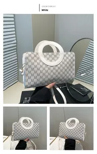 Detail of white square bag featuring grey M-letter print and stylish circular handle