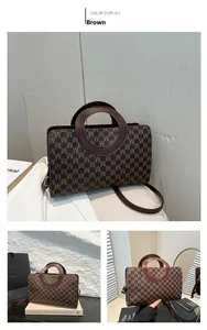 Detail of retro brown tote bag with repeating M patterns and stylish metal ring handle