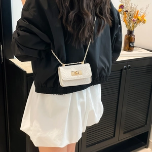 Mini white crocodile texture crossbody bag with gold chain strap shown on model back