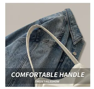 Detailed close-up of the comfortable white PU leather handbag handle with neat stitching