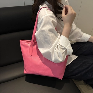Pink crocodile-embossed faux leather tote bag with long straps for chic urban style