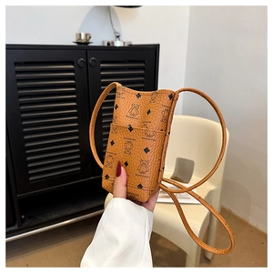 Detail of orange brown bucket bag with bear print and textured litchi leather finish