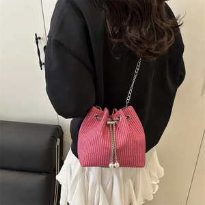 Chic pink woven corduroy bucket bag with pearl drawstring and silver chain strap
