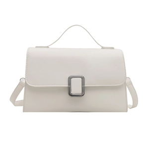Minimalist white leather crossbody bag with silver buckle and top handle on white background