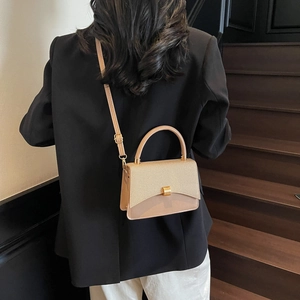 Minimalist beige patchwork crossbody bag with textured fabric and gold turn-lock