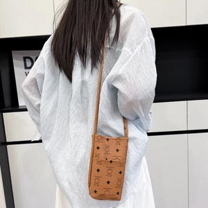 Vintage brown crossbody phone bag with black cartoon bear print and slim strap