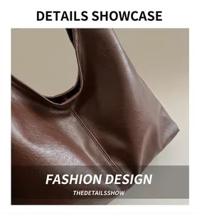 Close-up of deep brown oil wax leather texture and fine stitching on a tote bag