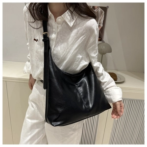 Hobo bag detail showing high-quality black faux leather texture and gold hardware accents