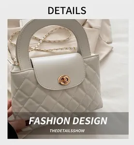 Detail of white quilted faux leather texture with gold circular metal twist lock closure