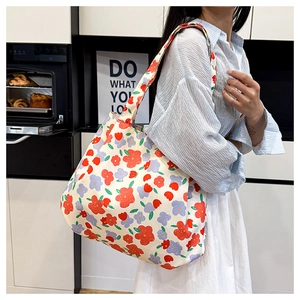 Detailed view of lightweight floral canvas tote bag with wide straps for shoulder wear