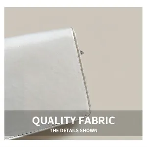 Detailed macro shot of premium white faux leather texture and precise stitching on bag