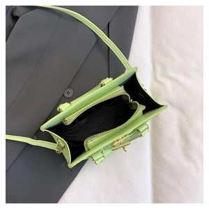 Overhead view showing the spacious interior compartments of this green leather handbag
